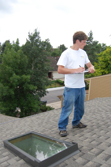 man measuring rooftop for solar installation