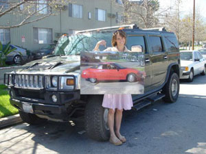 Alexandra Paul poses in front of a GM Hummer.