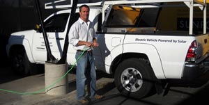 pick-up truck plugging into solar-charging station