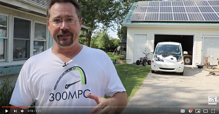 man standing in front of electric car and home solar system